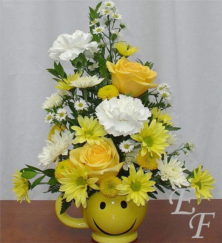 Happy Face Mug filled with bright flowers
