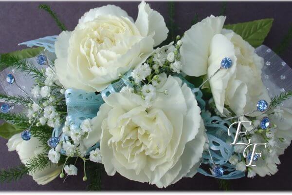 Corsage with miniature white carnations