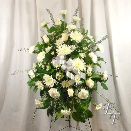 Fugi mums, roses, and carnations are accented with Ecylyptus and September Flower.