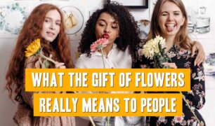 Three happy women holding flowers